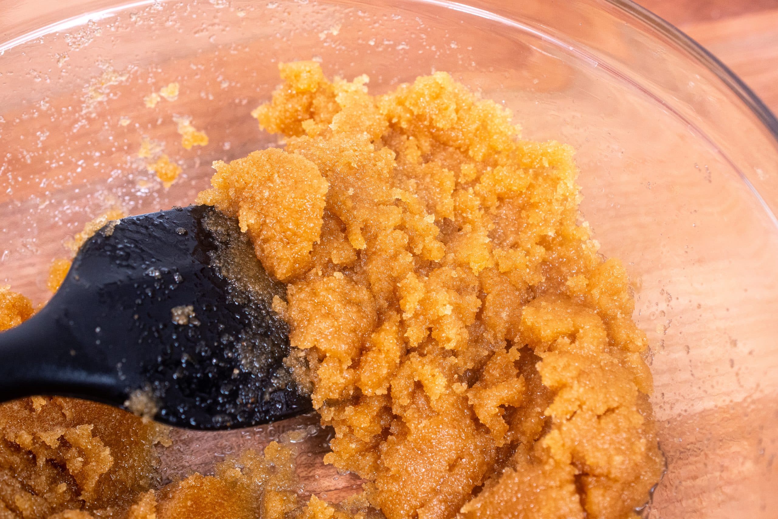 Brown sugar and butter being mixed for cookies.