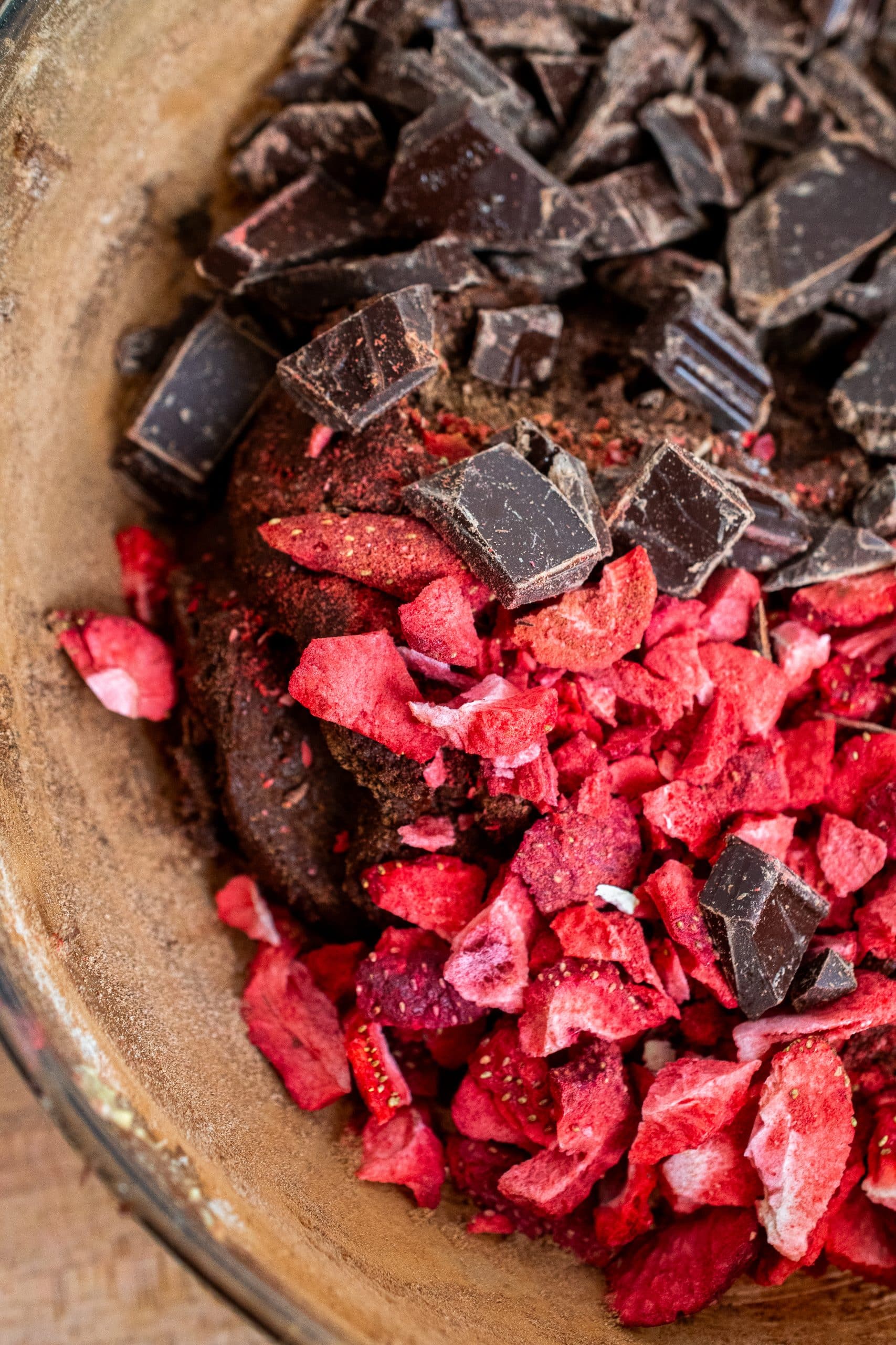 Close-up of chocolate pieces and freeze-dried strawberry chunks.