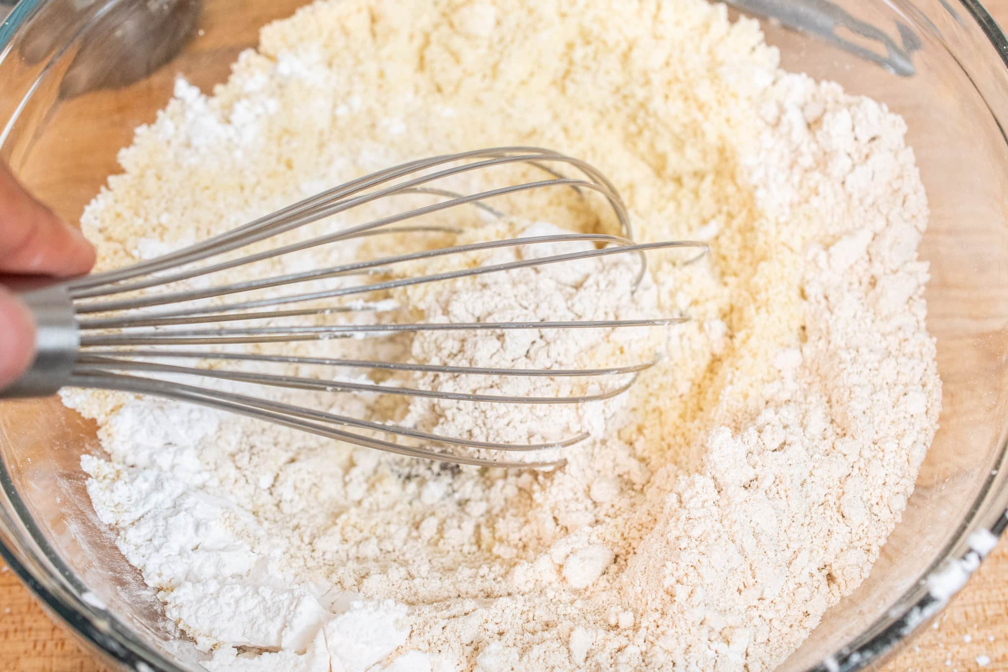 Whisking almond flour, oat flour, tapioca starch, baking soda, baking powder and salt together.