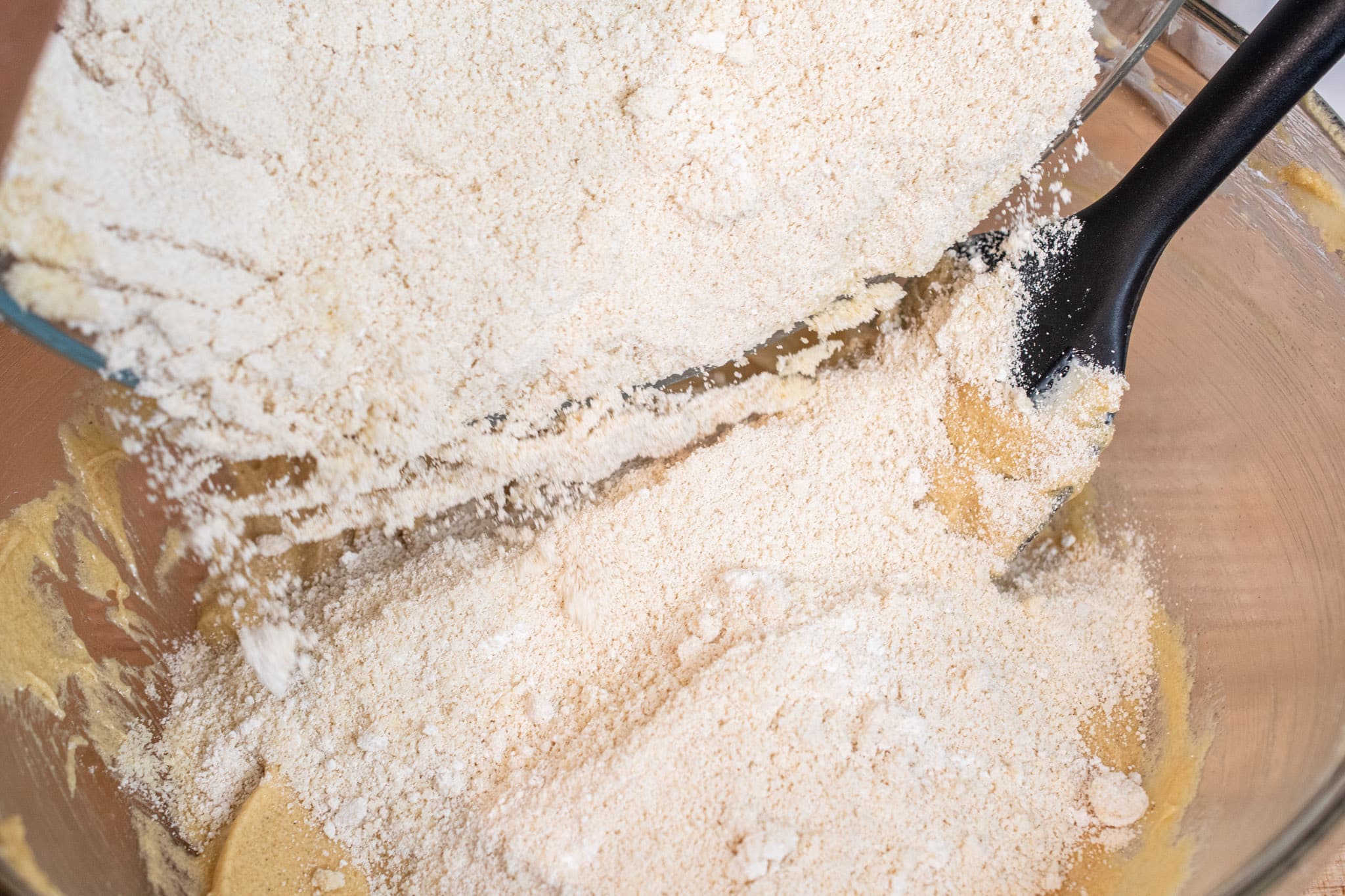 Adding dry ingredients to the butter mixture.