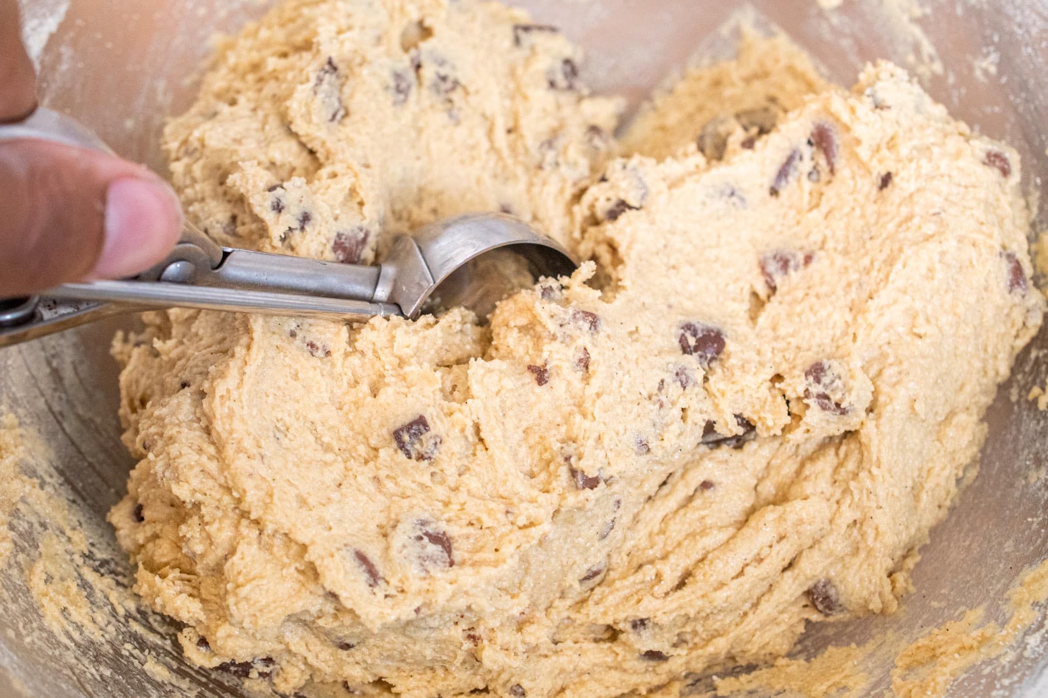 Scooping gluten free chocolate chip dough.