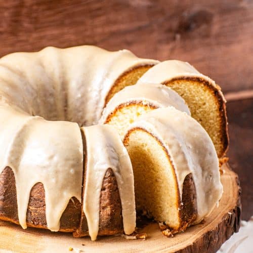 Brown Butter Pound Cake with rich brown butter glaze, sliced and served on a wooden cake stand
