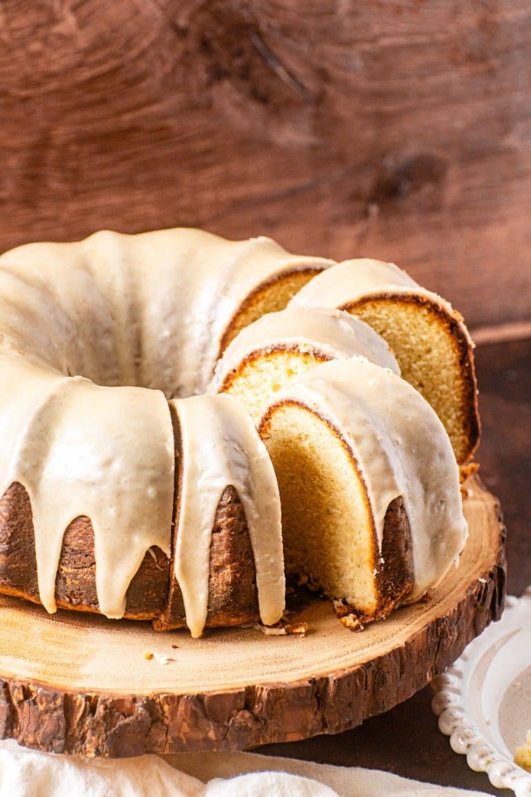 Brown Butter Pound Cake with rich brown butter glaze, sliced and served on a wooden cake stand