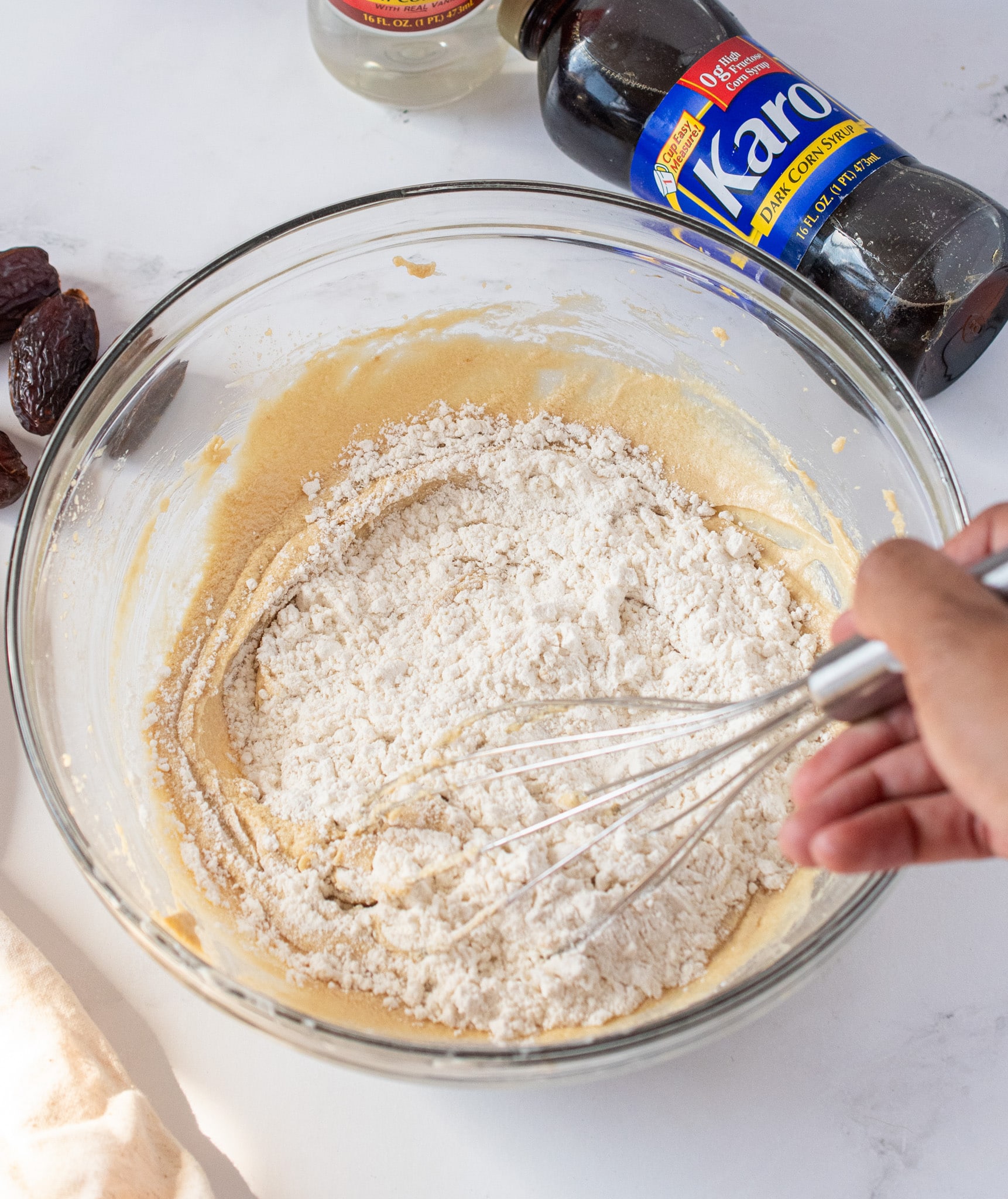 Whisking in flour to the wet ingredients.