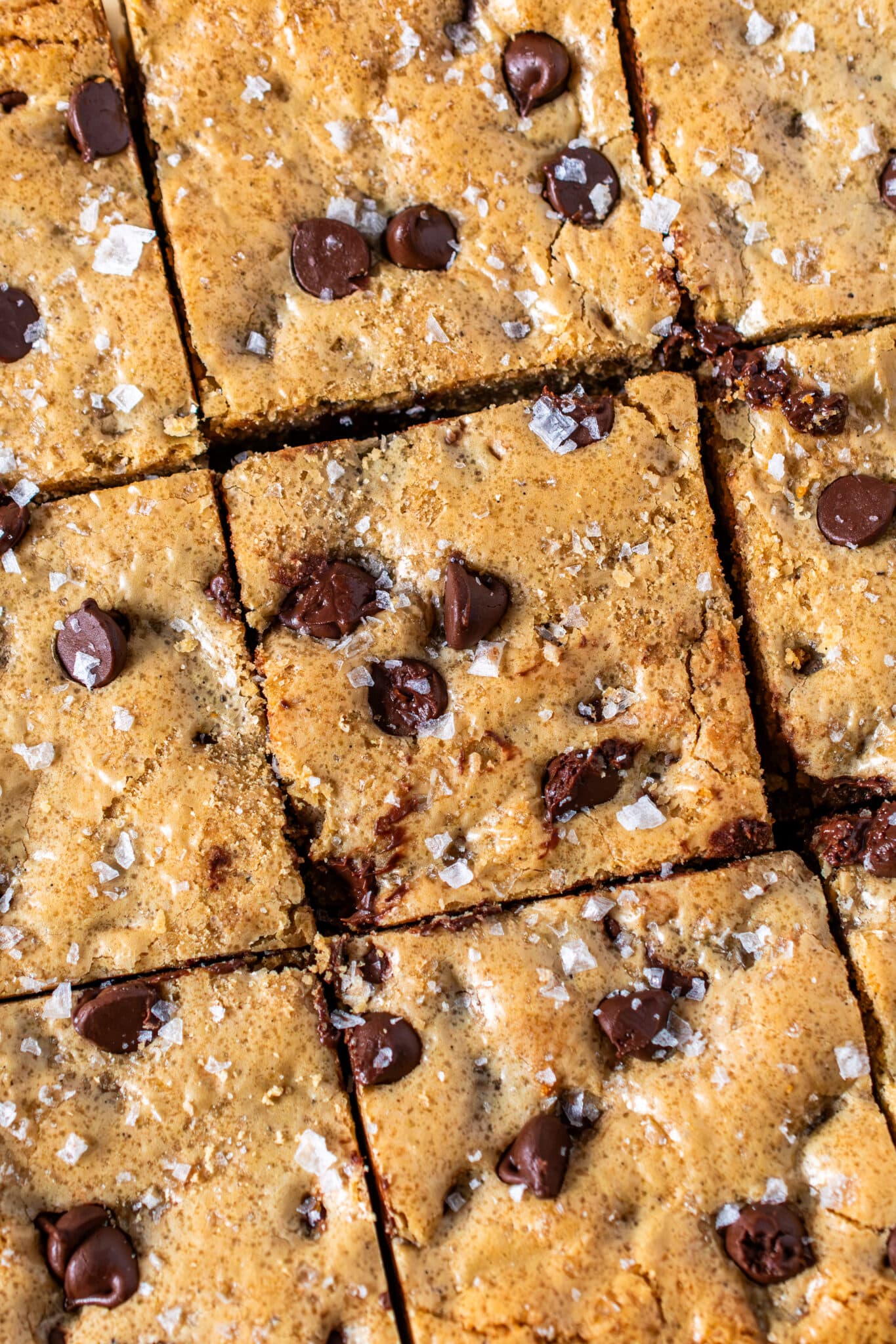 Sliced chocolate chip blondies topped with flaky salt and melty chocolate chips