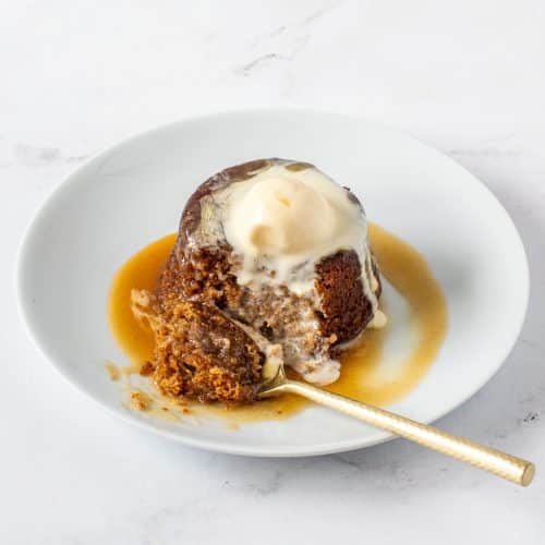 Sticky toffee pudding with vanilla ice cream and warm toffee sauce — rich, buttery, and perfectly moist.