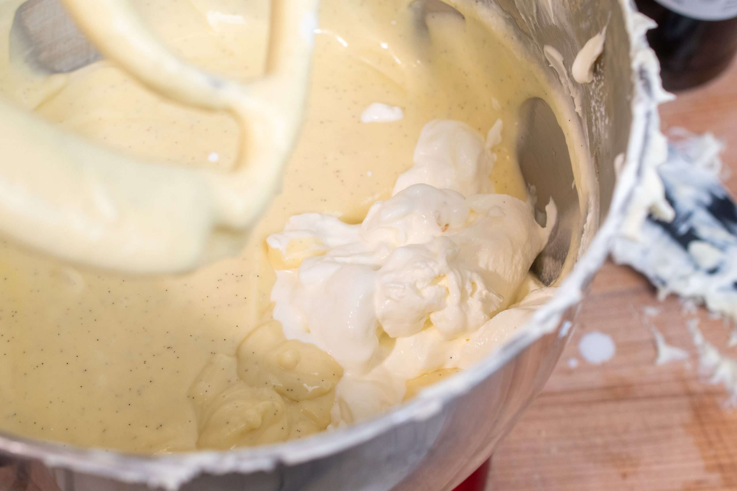 Adding in sour cream to the cheesecake batter to create a smooth texture.