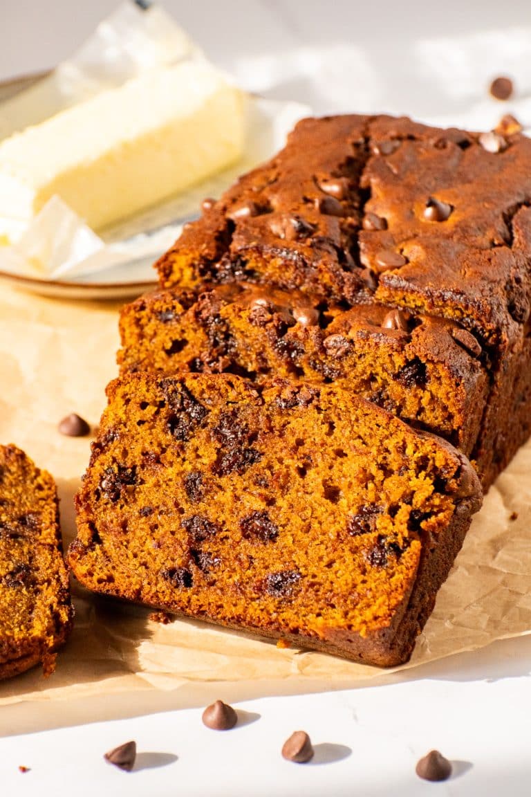 Moist pumpkin chocolate chip bread loaf sliced open to reveal a rich, soft crumb filled with melted chocolate chips.