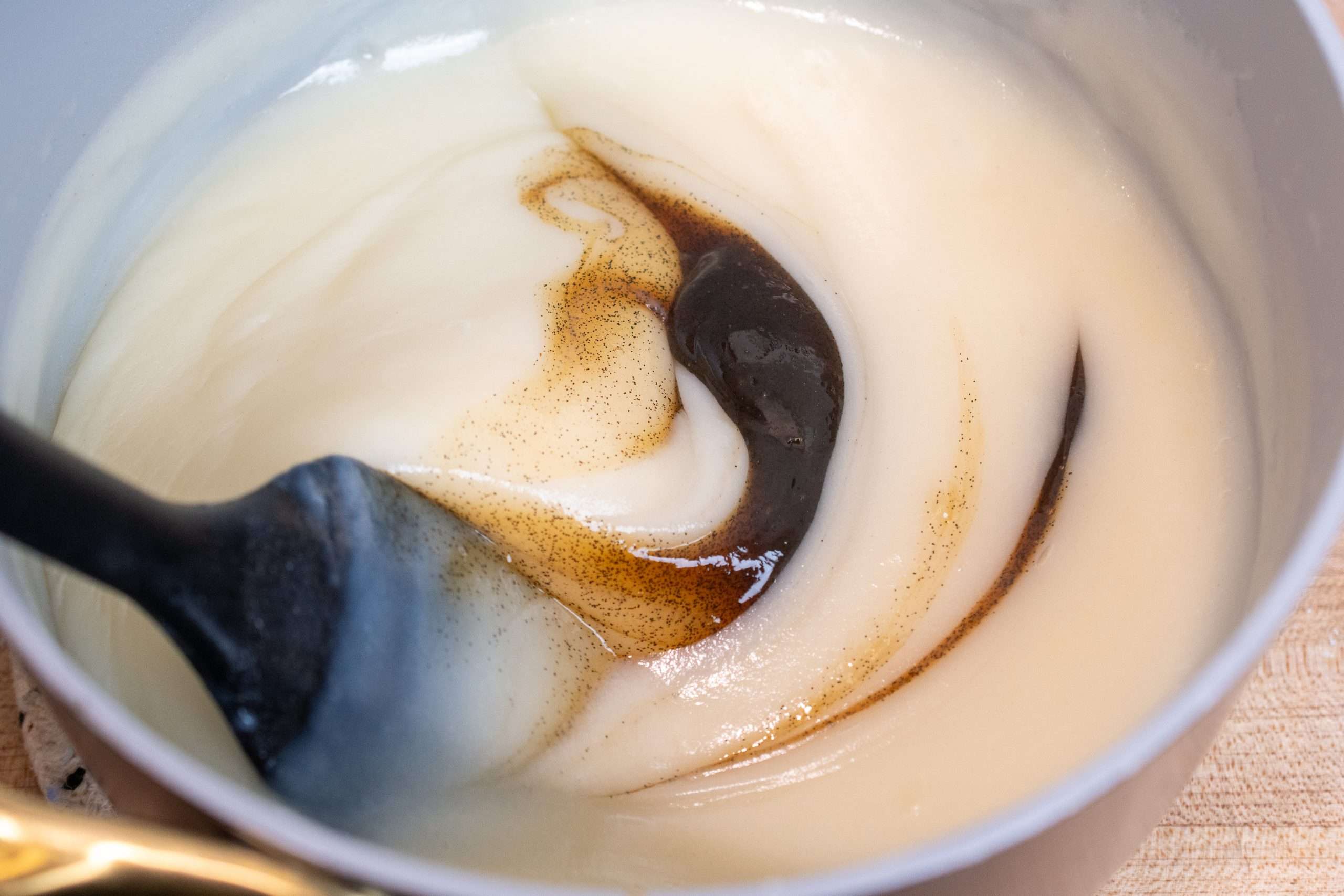 Adding vanilla bean paste to the cooked flour mixture.