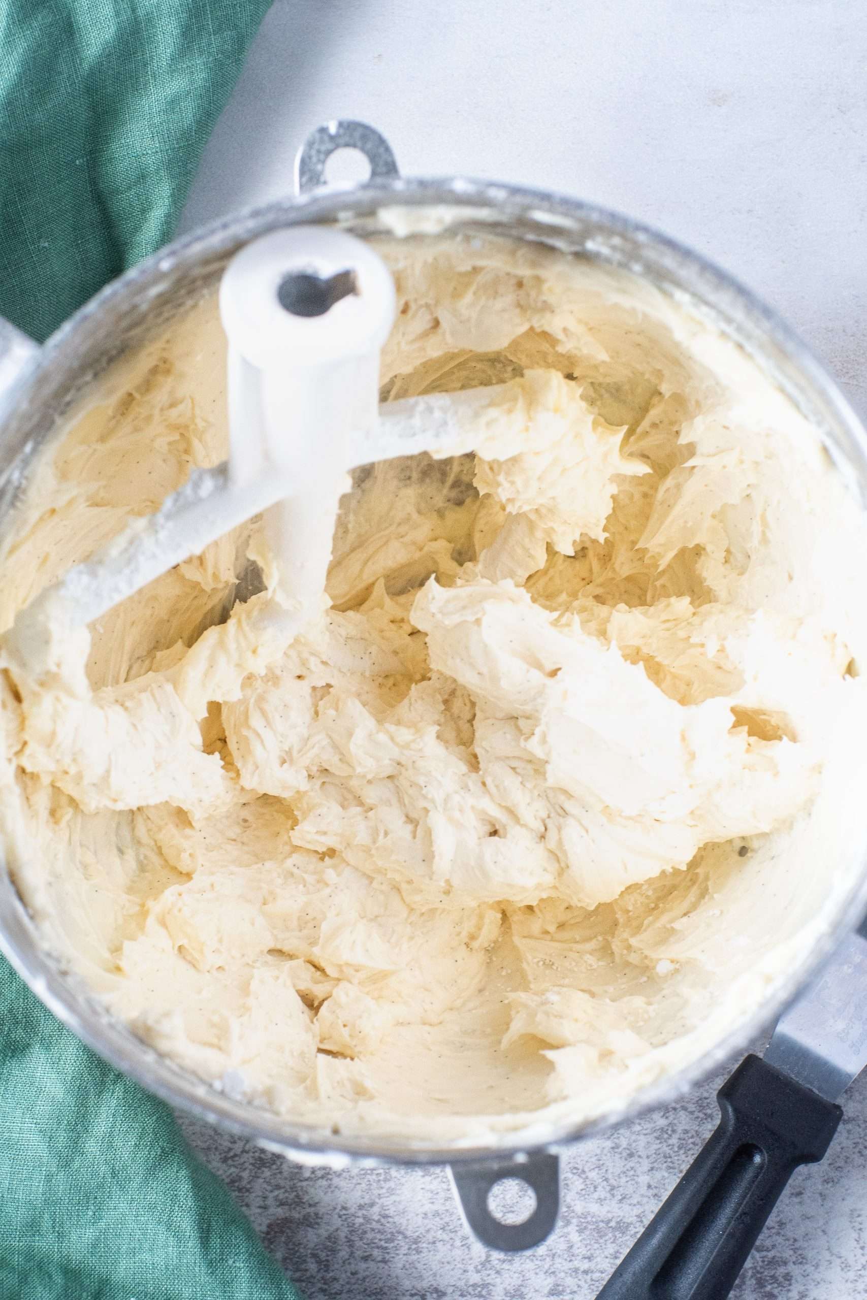 Fluffy vegan buttercream in a stand mixer bowl with paddle attachment, ready for decorating.