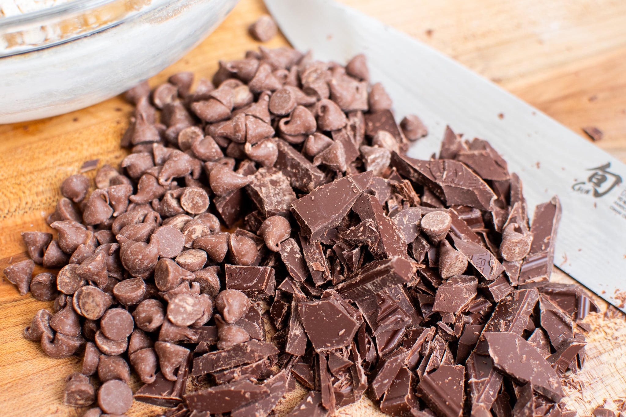 Chopped chocolate and chocolate chips together for cookies.