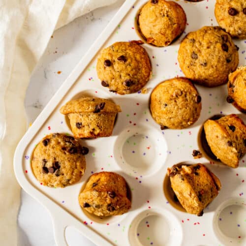 Mini banana muffins in white mini muffin pan overhead view
