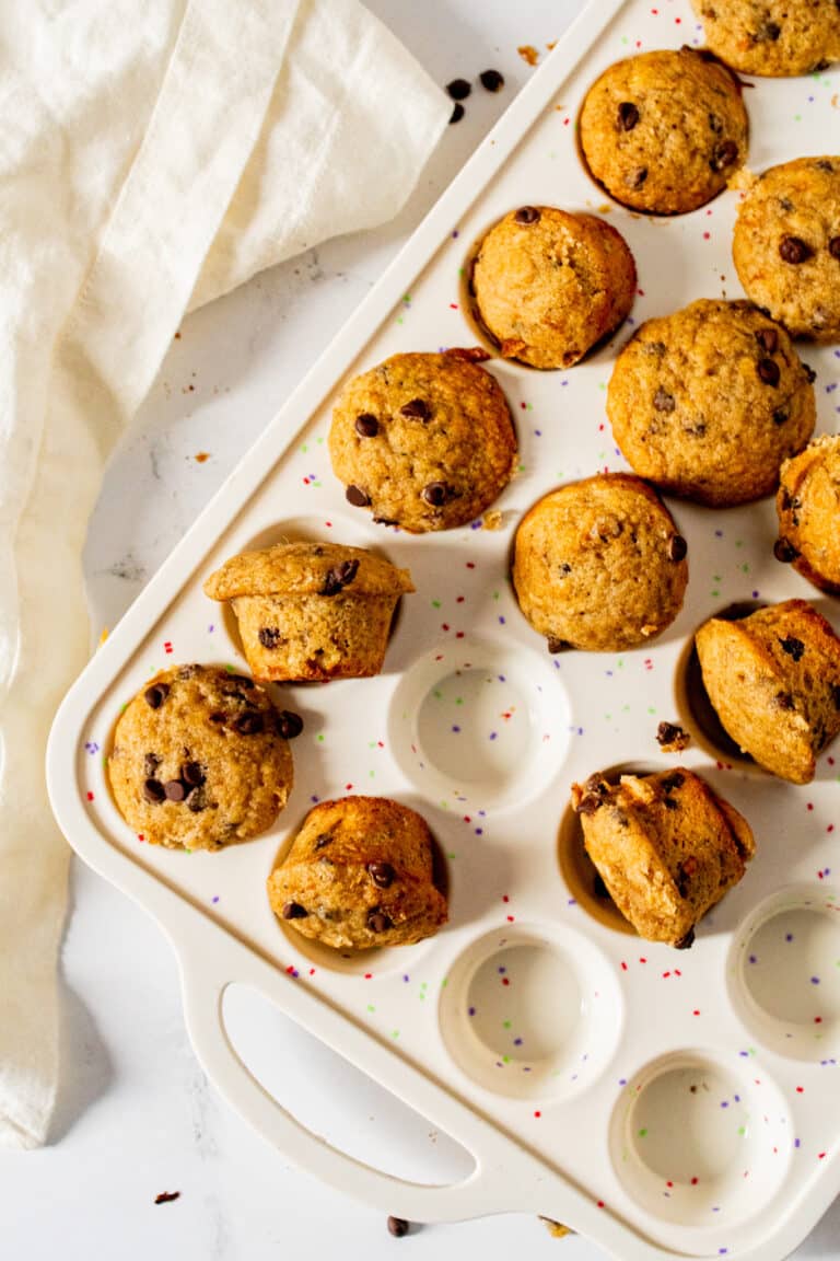 Mini banana muffins in white mini muffin pan overhead view