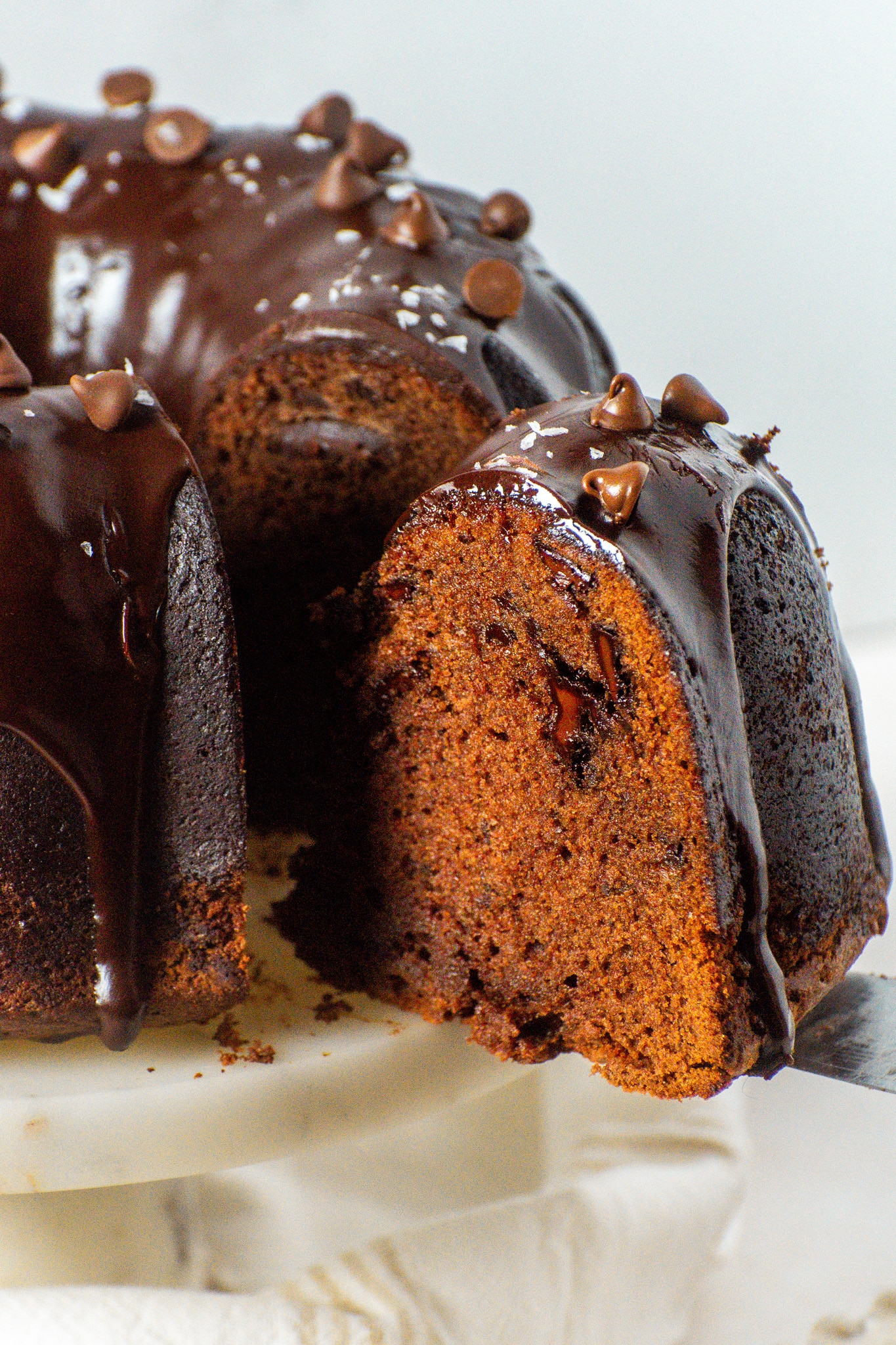 Moist chocolate pound cake with a glossy chocolate glaze and melted chocolate chunks