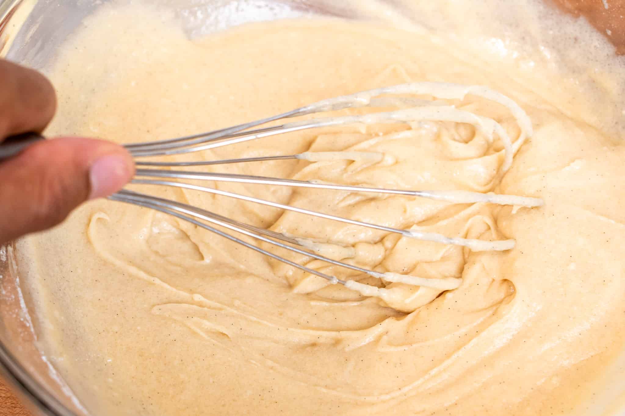 Whisking together the ingredients to create a smooth thick batter.