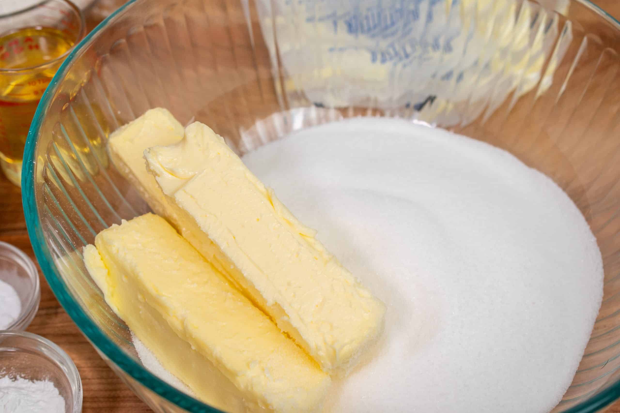 Softened butter and granulated sugar in a mixing bowl, ready for creaming.