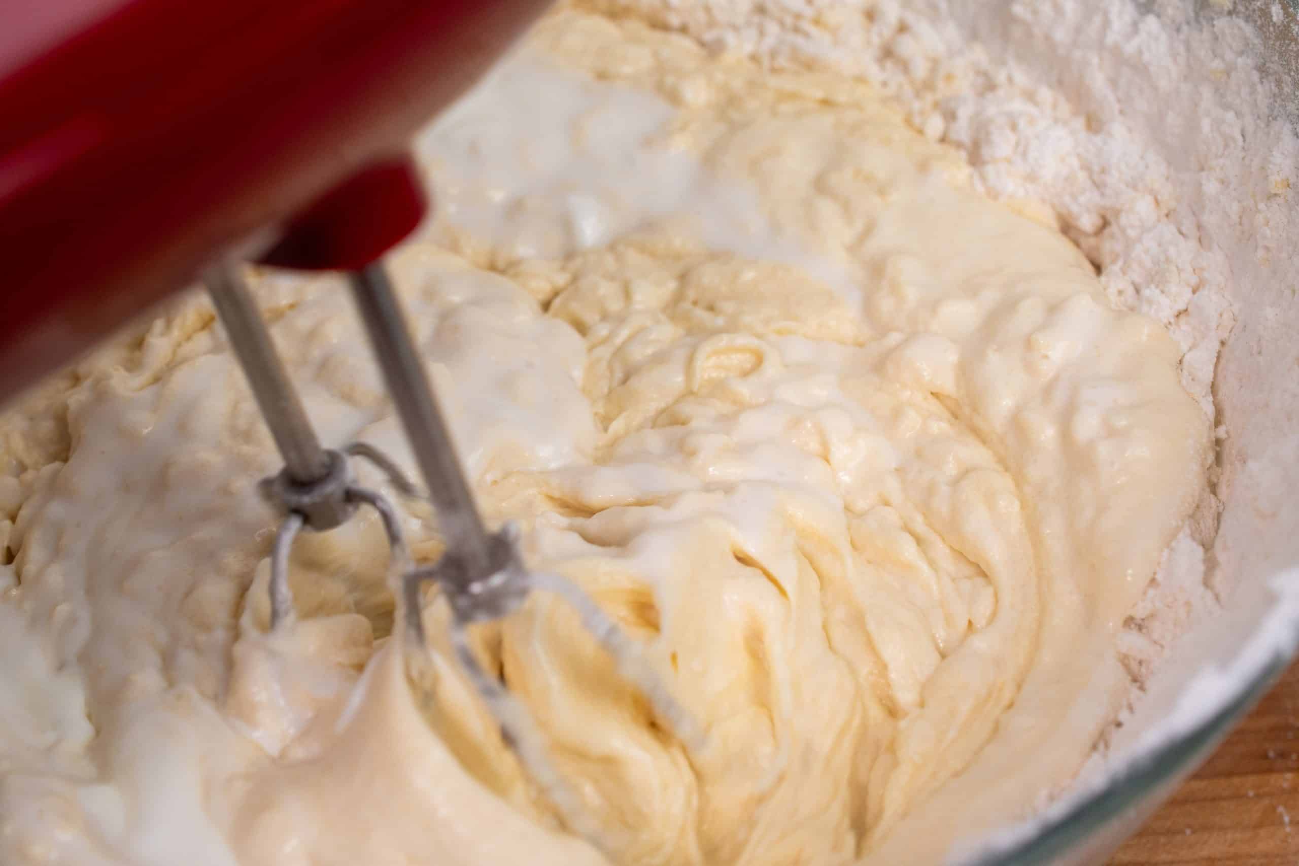 Mixing batter with buttermilk for a smooth texture.