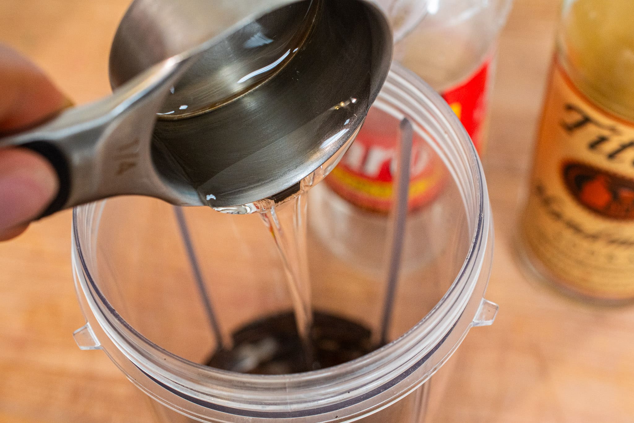 Adding corn syrup into the blender.