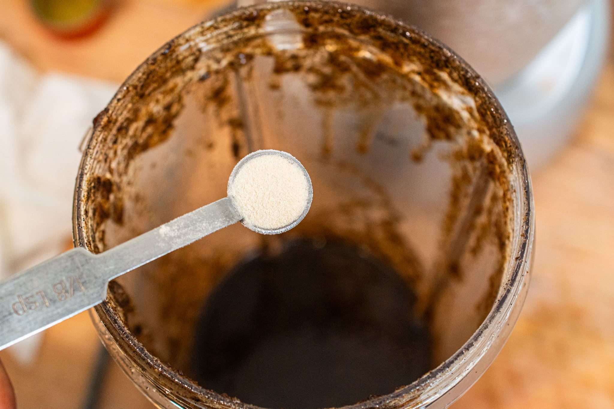 Adding xanthan gum into the mixture to thicken it.