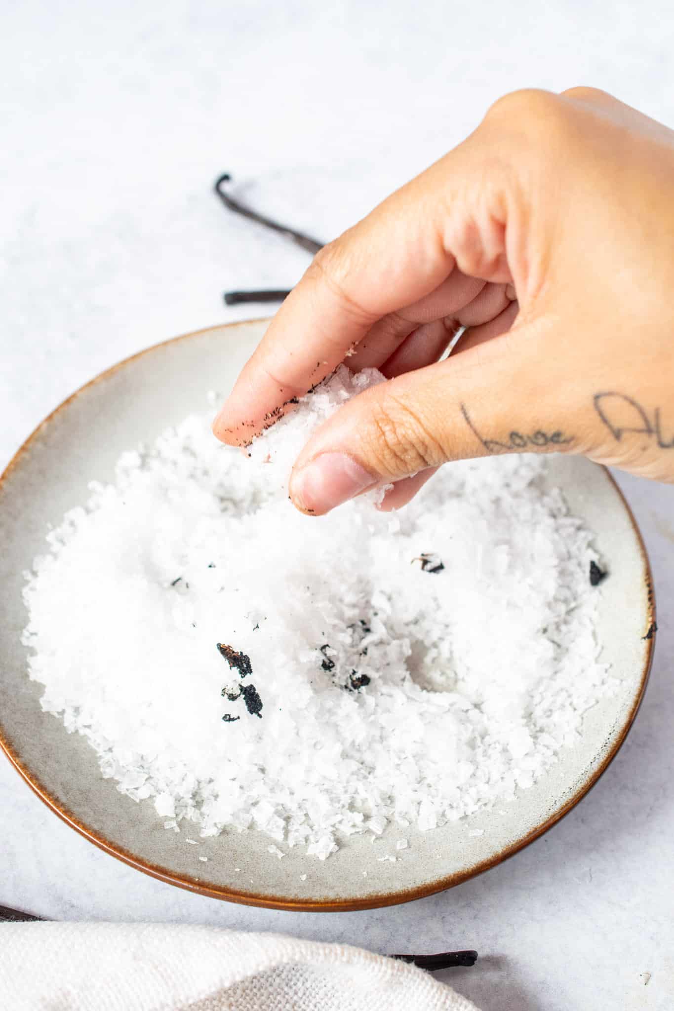 Crushing together sea salt with the seeds to enhance flavors.
