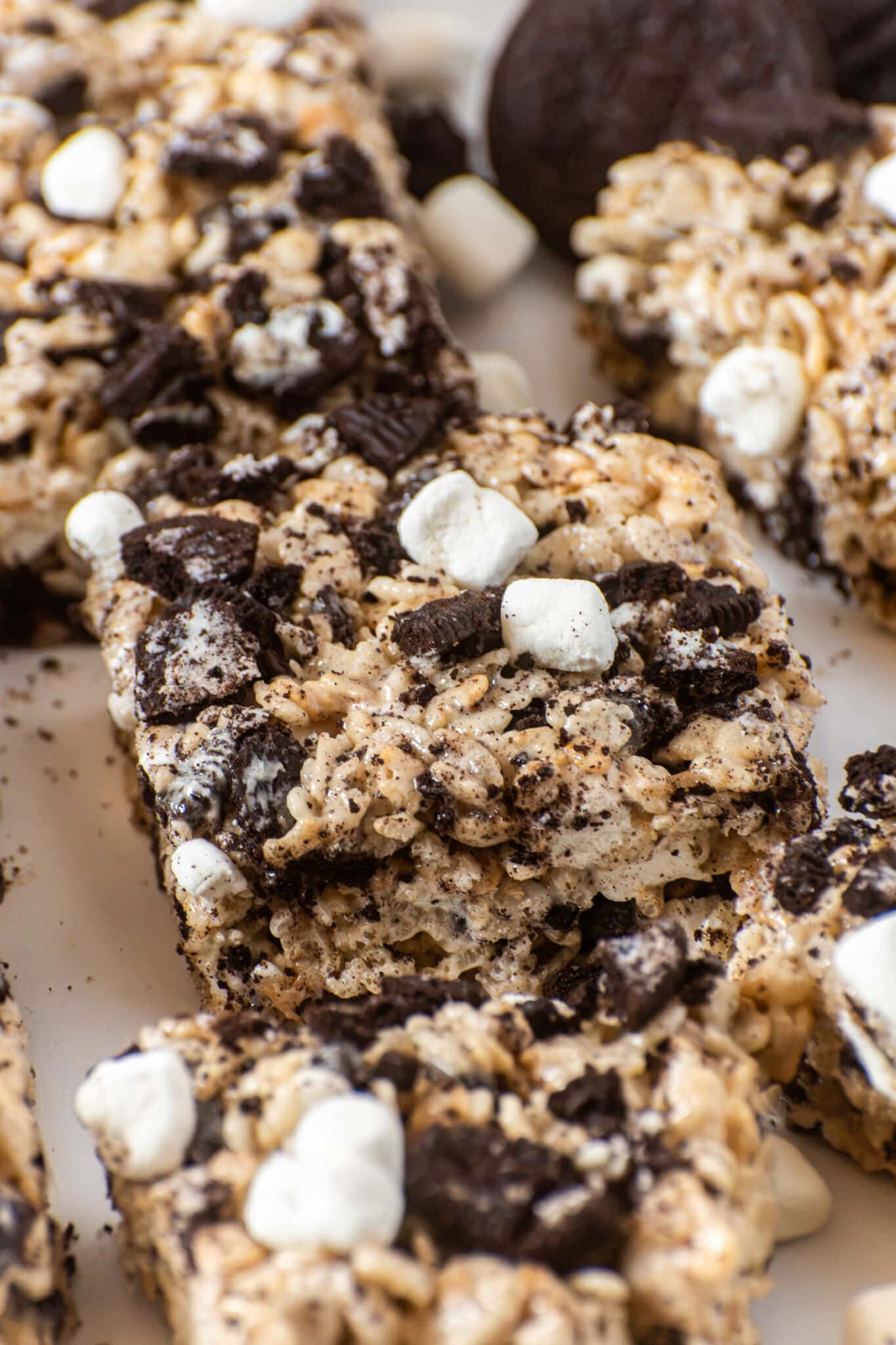 Close-up of gooey Oreo Rice Krispie Treats topped with chopped Oreos and mini marshmallows