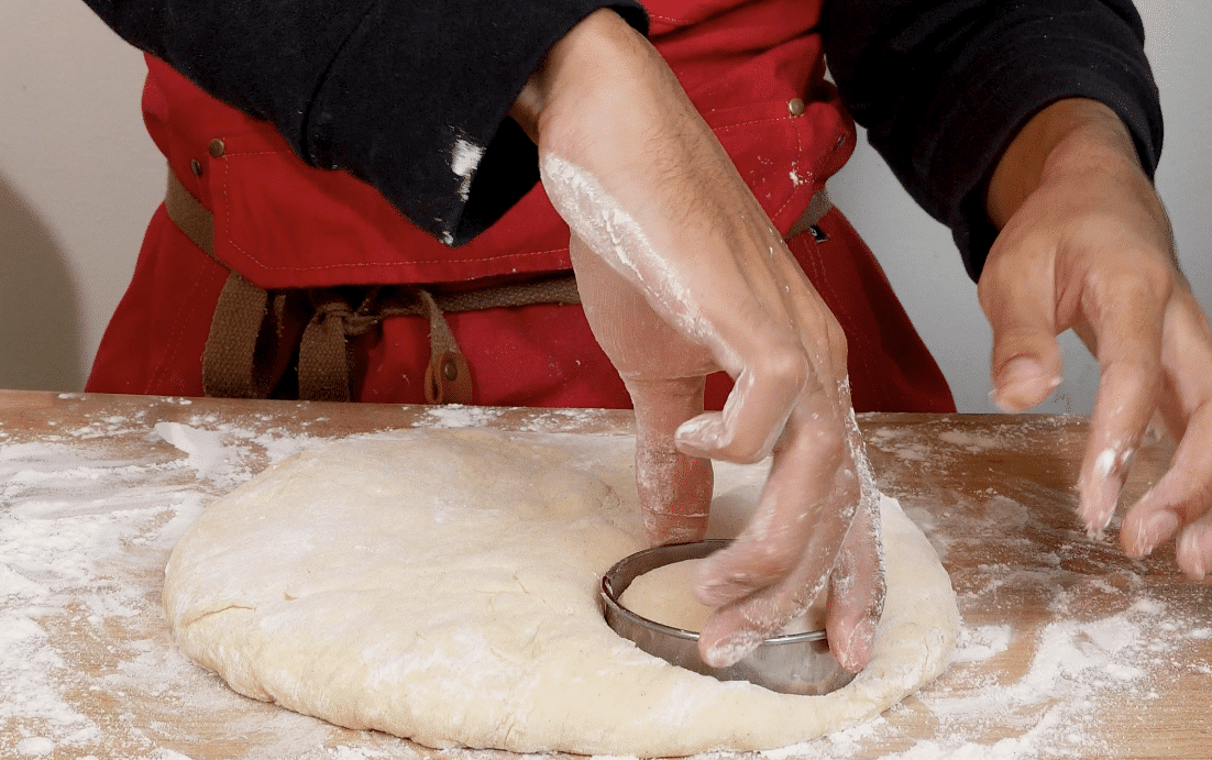 Cutting out the dough with a round cutter