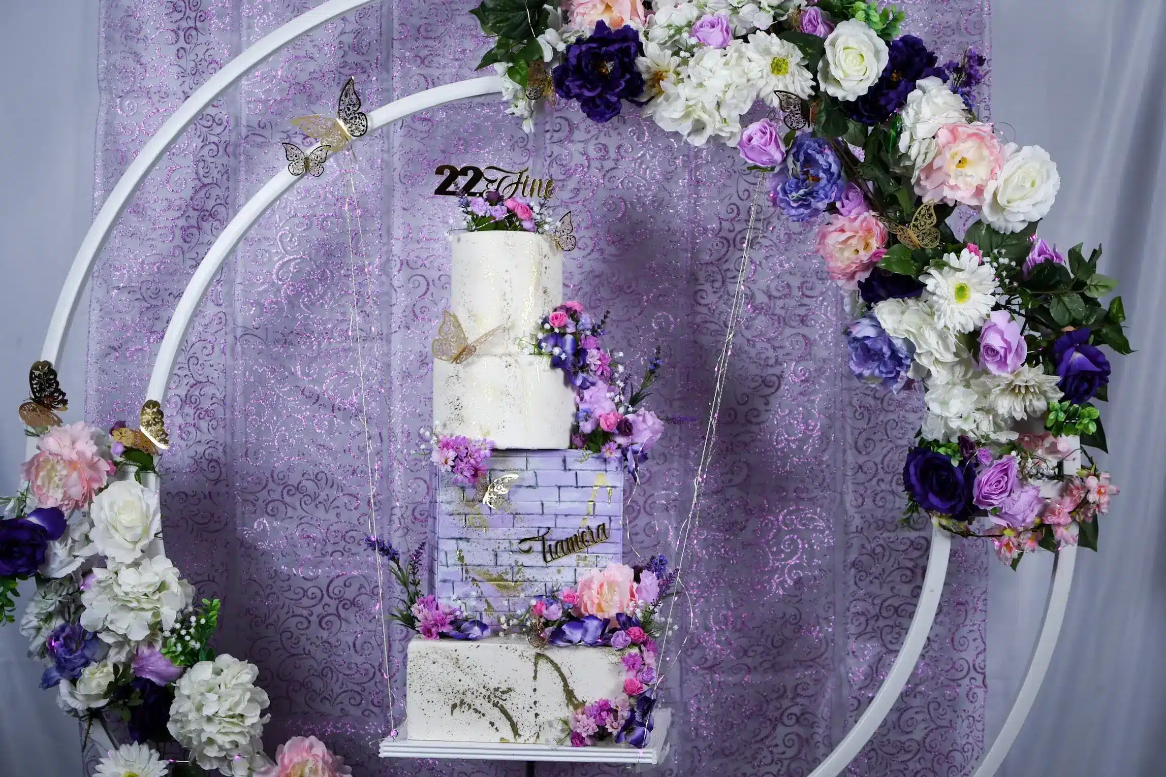 Elegant purple cake with floral decorations, perfect for garden parties or nature-inspired celebrations.